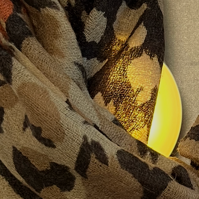 Close-up of soft and lightweight orange wool cashmere fabric with leopard design