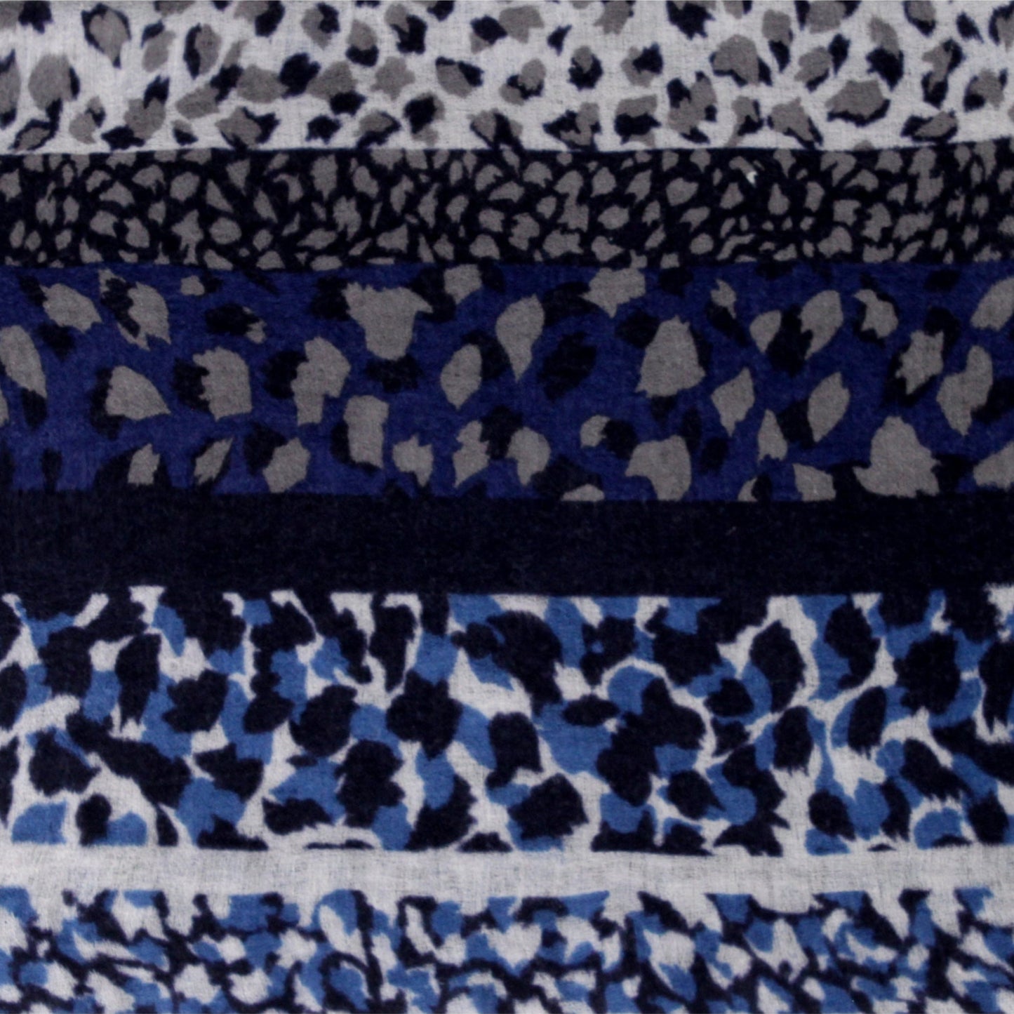 Close-up of soft blue wool cashmere fabric with leopard print texture